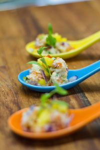 Close-up of food served in spoons on table