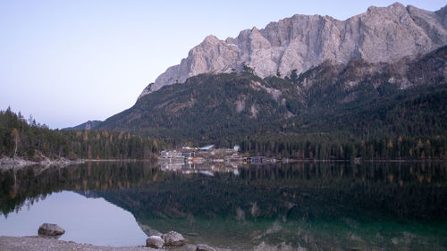 Scenic view of lake and mountains against clear sky