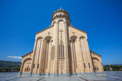 Low angle view of historical church against clear blue sky