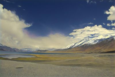 Scenic view of lake and mountains against sky
