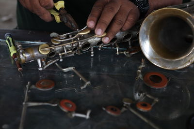 High angle view of man working on metal