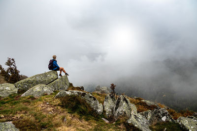 Man standing on mountain against sky