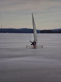 Fishing boat on lake against sky