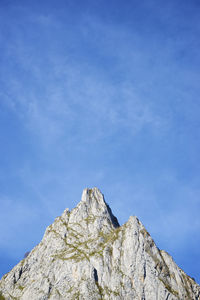 Low angle view of rock formation against blue sky