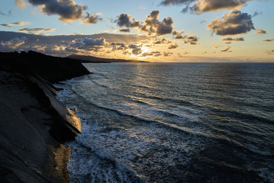 At the edge of steep and rugged cliffs of the gulf of biscay bay near st. jean de luz