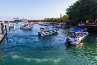 Boats moored in sea against sky