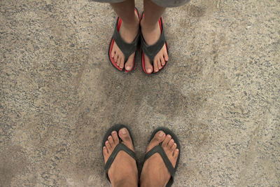 Low section of two men standing on beach