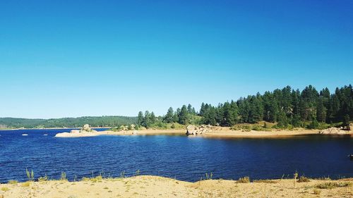 View of calm sea against clear blue sky