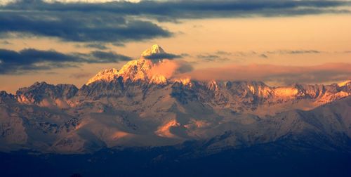 Scenic view of snowcapped mountains against sky during sunset