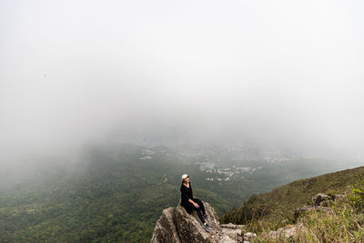 Man with arms raised on mountain