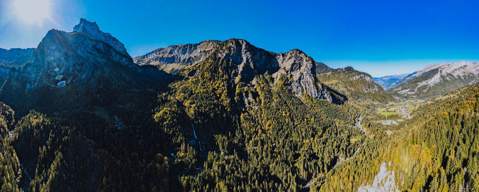 Scenic view of mountains against clear blue sky