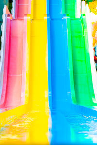 Close-up of multi colored bottles in swimming pool