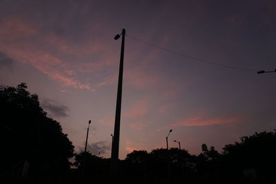 Low angle view of silhouette street against sky during sunset