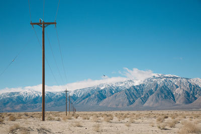 Scenic view of mountains against blue sky