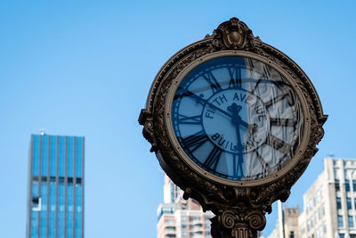 Low angle view of clock tower against clear sky