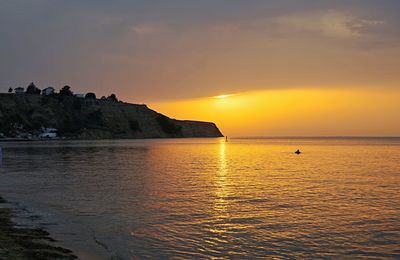 Scenic view of sea against sky at sunset