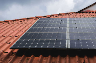 Low angle view of building roof against sky