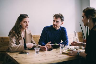 Young couple sitting on table