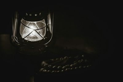 Close-up of wine glass on table against black background