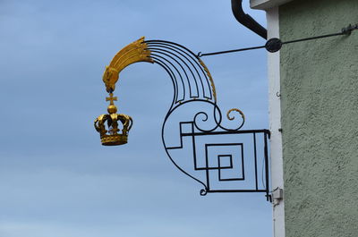 Low angle view of sign against sky