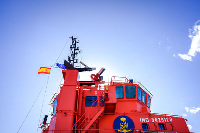 Low angle view of crane against blue sky