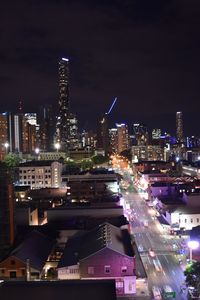 Illuminated cityscape against sky at night