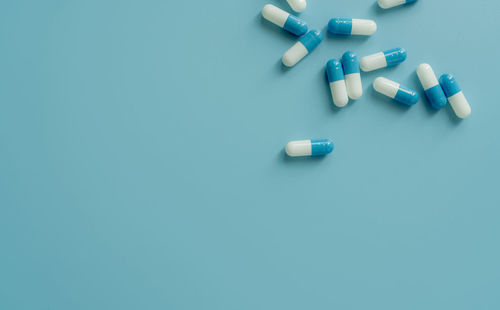 High angle view of pills on blue background