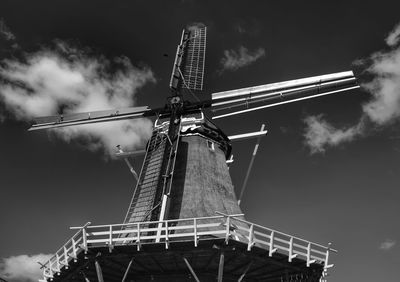 Low angle view of traditional windmill against sky