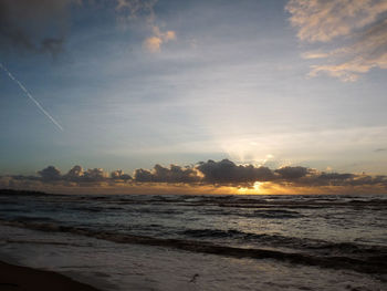 Scenic view of beach against sky during sunset