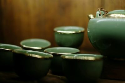 Close-up of green cups and kettle
