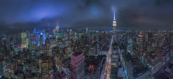 Aerial view of illuminated buildings in city at night