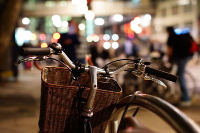 Close-up of illuminated lighting equipment in basket at night