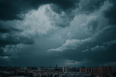 Storm clouds over city buildings