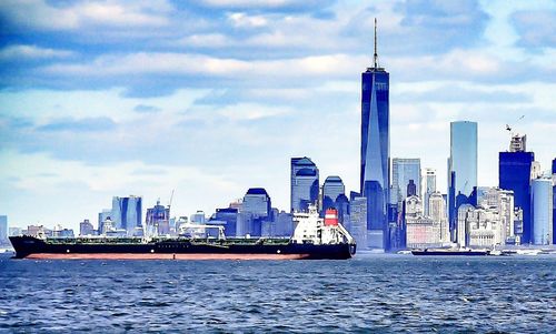 View of cityscape against cloudy sky