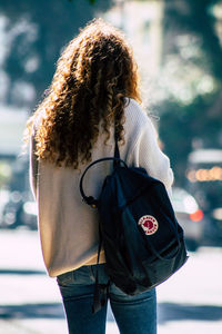 Rear view of woman standing outdoors