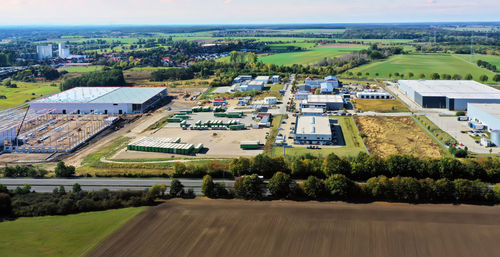 Aerial view of a new industrial area with a construction site for a hall on the outskirts