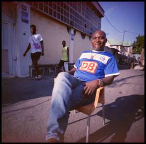 Full length of men sitting on street in city