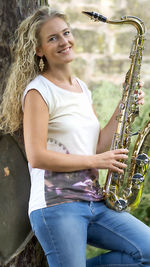 Portrait of a smiling young woman playing outdoors