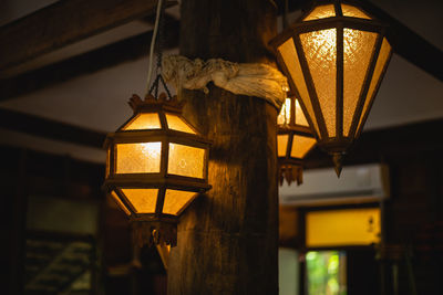 Low angle view of illuminated lanterns hanging from ceiling 