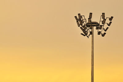 Low angle view of floodlight against sky