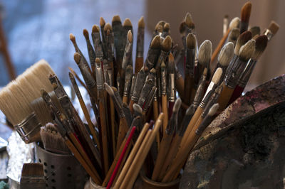 Close-up of paintbrushes in containers