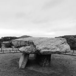 Scenic view of rocks on field against sky