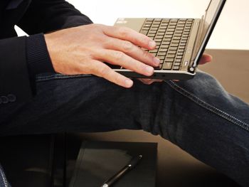 Midsection of man using laptop