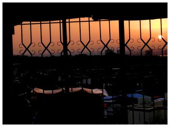 Silhouette of illuminated lights at sunset