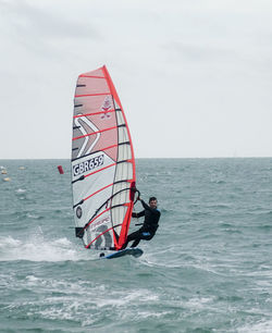 Rear view of man surfing in sea