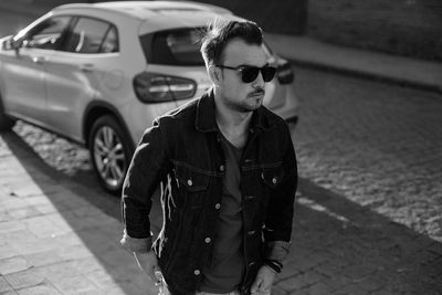 Young man wearing sunglasses on street