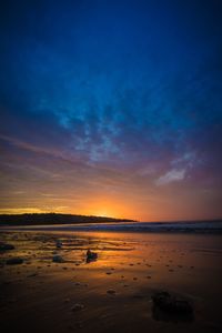 Scenic view of beach against sky during sunset