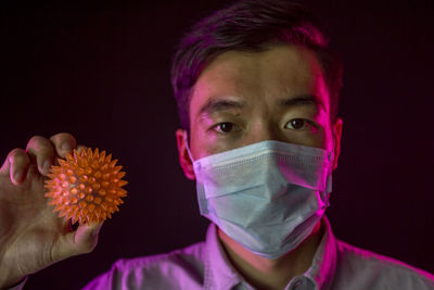 Close-up portrait of young man against black background