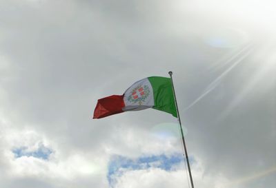 Low angle view of flag flags against sky