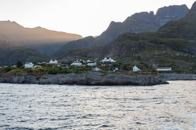 Scenic view of sea and mountains against sky